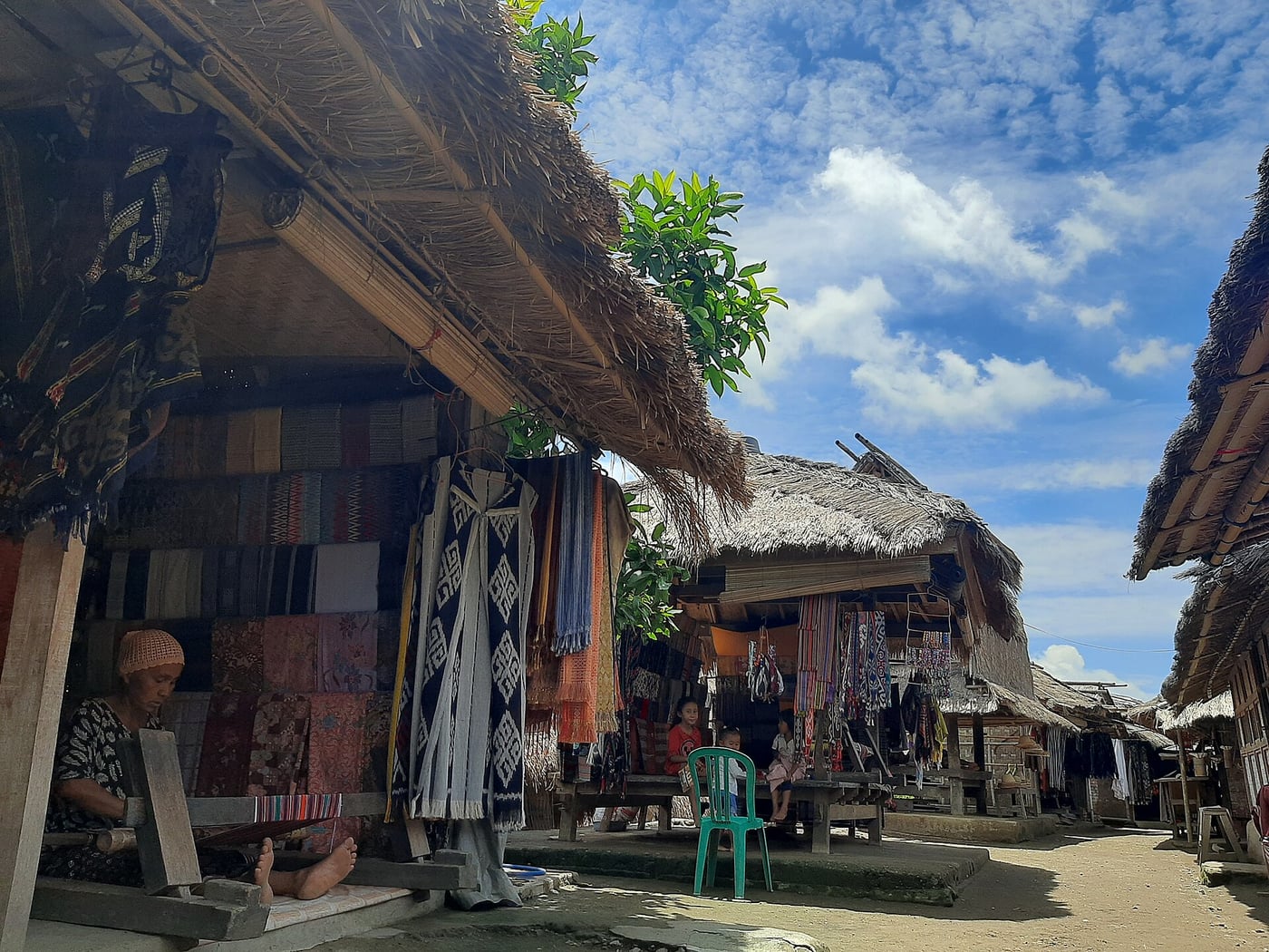 Thatched houses and textile stalls in Sade traditional village, photographed in 2020