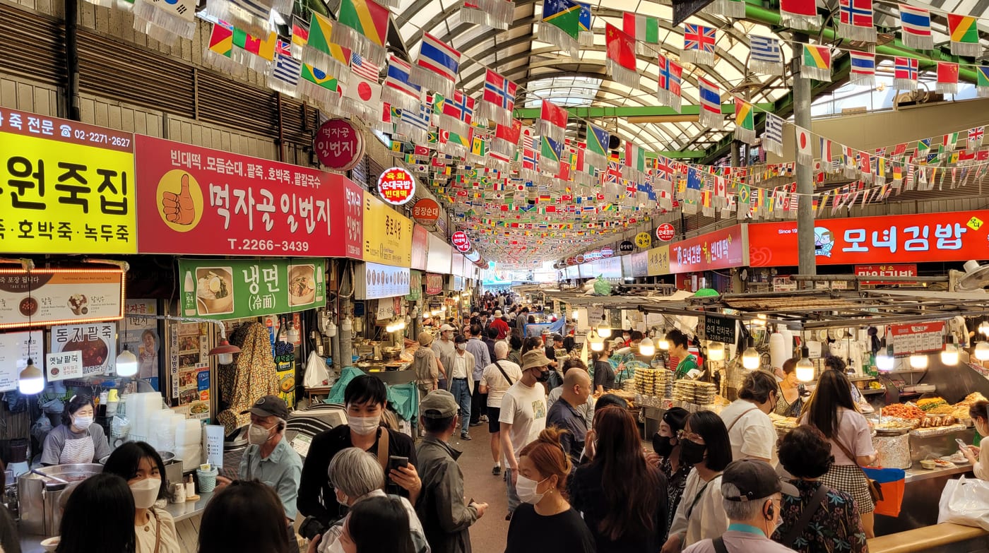 Food stalls and visitors inside Gwangjang Market