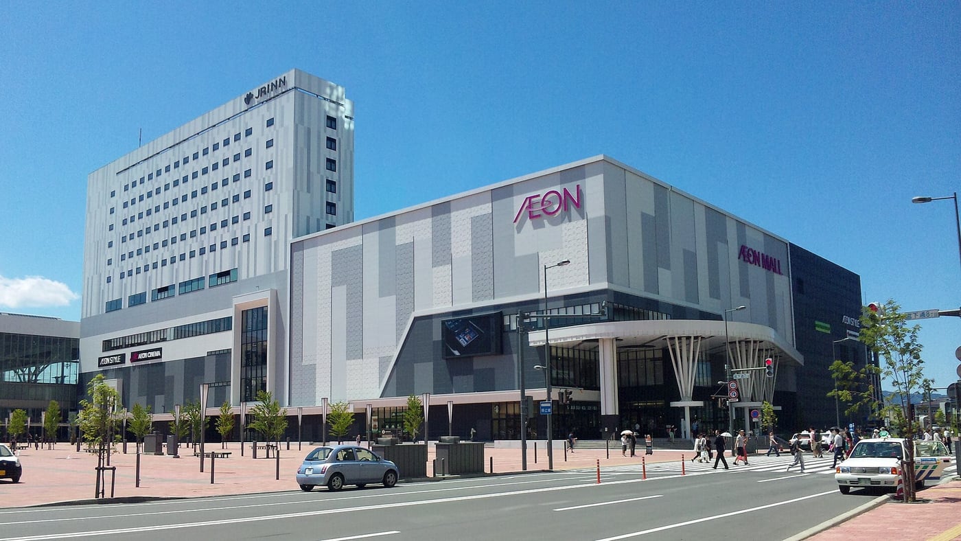 AEON Mall and the JR Inn building beside Asahikawa Station, with the road by the station plaza