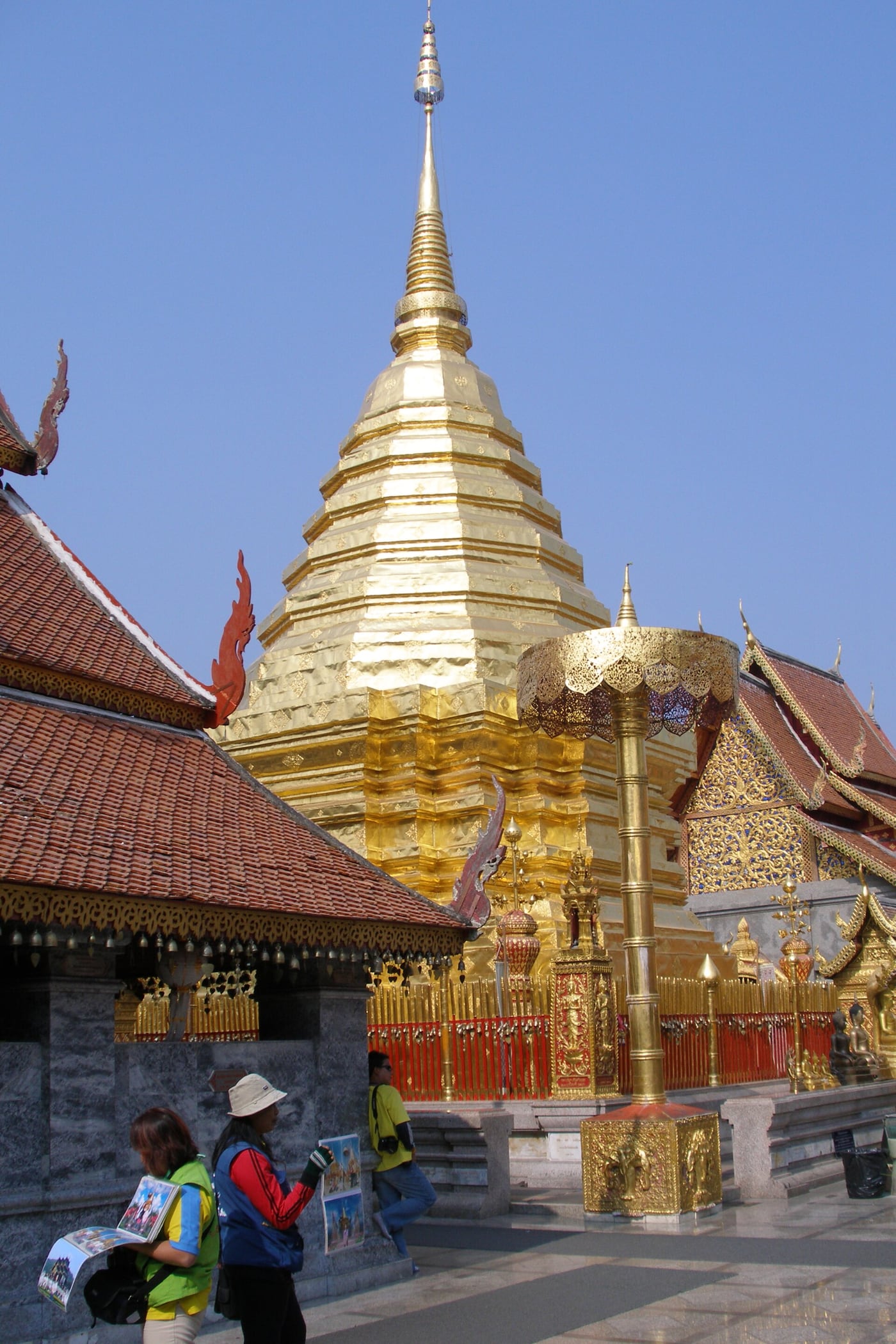 The golden chedi, red tiled roofs and ornate ceremonial umbrella at Doi Suthep temple