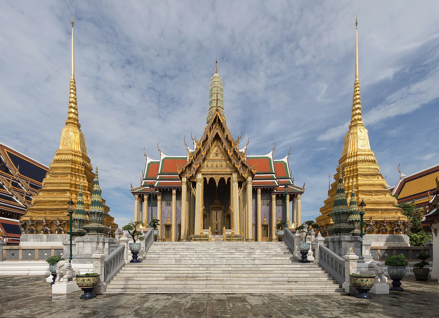 Prasat Phra Thep Bidorn flanked by two golden chedis at Wat Phra Kaew in Bangkok's Grand Palace complex
