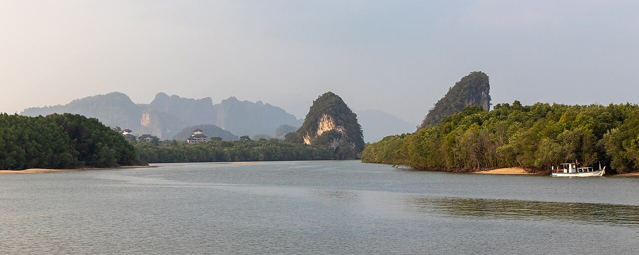 Limestone peaks of Khao Khanab Nam and mangrove banks across the Krabi River