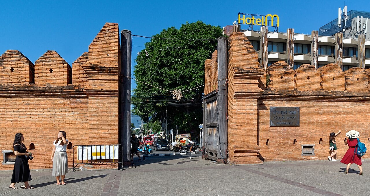 The red brick walls and open doorway of Tha Phae Gate in Chiang Mai