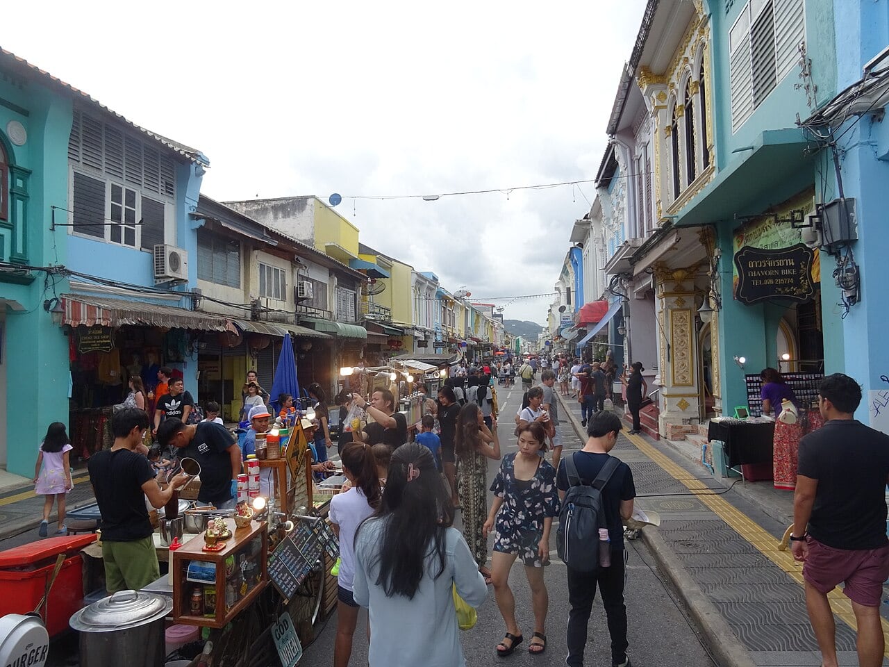 A weekend market among colorful shophouses on Phuket's Thalang Road; market operation depends on the visit date