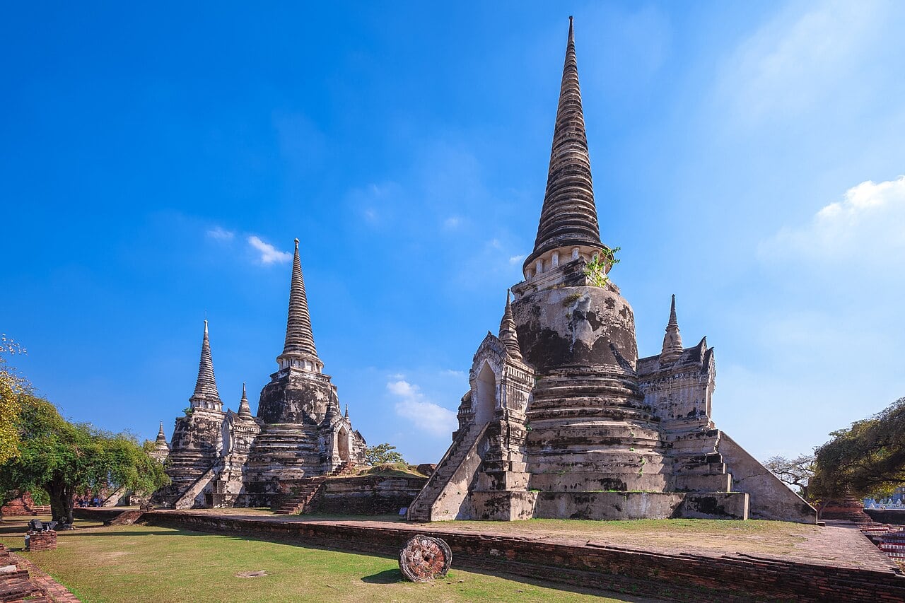 Three chedis and the grassy historic grounds of Wat Phra Si Sanphet